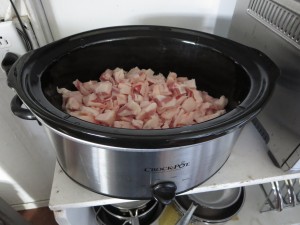 Load all the little back fat pieces into the slow cooker and tun on "low." You can also do it on the stove-top on a low setting as long as you watch it carefully.